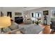 Comfortable living room features a piano and large window with backyard views at 8990 Pickwick Dr, Indianapolis, IN 46260