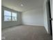 Bright bedroom featuring neutral carpet, a large window, and fresh paint, perfect for relaxation at 915 Saddlebrook Farms Blvd, Whiteland, IN 46184