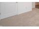 Neutral carpet in a bedroom with white trim, a closet door, and a view to an adjacent room at 915 Saddlebrook Farms Blvd, Whiteland, IN 46184