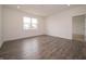 Well-lit bedroom featuring laminate flooring, large window, and white walls at 915 Saddlebrook Farms Blvd, Whiteland, IN 46184