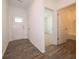 Bright entryway featuring wood-look flooring, white trim, and a view into an adjacent bedroom at 915 Saddlebrook Farms Blvd, Whiteland, IN 46184