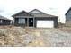 New single-story home featuring a brick facade and attached garage; exterior is awaiting final landscaping at 915 Saddlebrook Farms Blvd, Whiteland, IN 46184