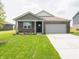 Charming one-story brick home with a well-manicured lawn, landscaping, and attached two car garage at 915 Saddlebrook Farms Blvd, Whiteland, IN 46184