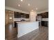Modern kitchen featuring an island, stainless steel appliances, and dark cabinets at 915 Saddlebrook Farms Blvd, Whiteland, IN 46184
