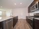 Modern kitchen featuring stainless steel appliances, dark cabinetry, and a spacious island at 915 Saddlebrook Farms Blvd, Whiteland, IN 46184