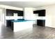 Modern kitchen featuring dark cabinets, a large center island, and wood flooring at 915 Saddlebrook Farms Blvd, Whiteland, IN 46184