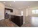 Open-concept kitchen with a stainless steel refrigerator, spacious island, and modern finishes at 915 Saddlebrook Farms Blvd, Whiteland, IN 46184