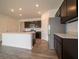 Modern kitchen featuring stainless steel appliances, dark cabinets and laminate floors at 915 Saddlebrook Farms Blvd, Whiteland, IN 46184