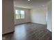 Open concept living room featuring recessed lighting, LVP floors, and a large window with beautiful backyard views at 915 Saddlebrook Farms Blvd, Whiteland, IN 46184