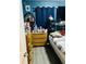 Bedroom featuring blue walls, full sized bed, wood floors, chest of drawers, and mirror at 918 N Olney St, Indianapolis, IN 46201