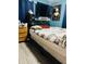 Bedroom includes full sized bed, wood floors, blue walls, and flat screen tv at 918 N Olney St, Indianapolis, IN 46201