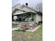 Front yard showing a small one story home with a covered porch at 918 N Olney St, Indianapolis, IN 46201