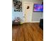 Cozy living room featuring wood floors, a recliner chair, and television at 918 N Olney St, Indianapolis, IN 46201