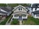 Aerial view of a charming two-story home with a welcoming front porch and professionally landscaped yard at 926 N Dearborn St, Indianapolis, IN 46201