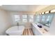 Bright bathroom with a soaking tub and dual sinks at 926 N Dearborn St, Indianapolis, IN 46201