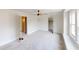 Large bedroom with doors to a closet and other rooms, neutral carpet, ceiling fan, and bright window at 926 N Dearborn St, Indianapolis, IN 46201