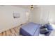 Bright bedroom with wood-look floors, a ceiling fan, and neutral decor at 926 N Dearborn St, Indianapolis, IN 46201