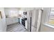 This kitchen is equipped with stainless steel appliances and white cabinets at 926 N Dearborn St, Indianapolis, IN 46201