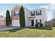 Charming two-story home featuring a brick facade, two-car garage, and well-manicured lawn at 951 Brookstone Dr, Franklin, IN 46131