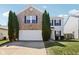 Charming two-story home featuring a brick facade, two-car garage, and well-manicured lawn at 951 Brookstone Dr, Franklin, IN 46131
