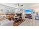 Cozy living room with a fireplace, plush seating, and a mounted TV for entertainment at 951 Brookstone Dr, Franklin, IN 46131