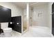 A modern bathroom with a shower/tub, tiled walls, and marble flooring at 953 Harrison St, Indianapolis, IN 46202