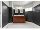 Bathroom featuring double vanity with dark wood cabinets, marble floors, and gray accent walls at 953 Harrison St, Indianapolis, IN 46202