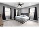 Cozy bedroom featuring a plush bed, ample natural light, and dark accent curtains at 953 Harrison St, Indianapolis, IN 46202