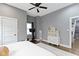 Bright bedroom featuring a ceiling fan, exercise bike, and built-in storage at 953 Harrison St, Indianapolis, IN 46202