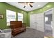 Comfortable bedroom featuring wood crib, natural light, and calming green walls at 953 Harrison St, Indianapolis, IN 46202