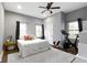 Spacious bedroom filled with natural light, ceiling fan, exercise bike, rocking horse and neutral decor at 953 Harrison St, Indianapolis, IN 46202