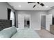 This bedroom features a ceiling fan, large bed, and closet at 953 Harrison St, Indianapolis, IN 46202