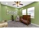 Charming bedroom featuring a wooden crib, reclining chair, and playful decor at 953 Harrison St, Indianapolis, IN 46202