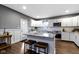 Charming kitchen featuring granite countertops, a kitchen island with bar seating, and stainless steel appliances at 953 Harrison St, Indianapolis, IN 46202