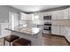 Well-lit kitchen with white cabinetry, a center island, and stainless-steel appliances at 953 Harrison St, Indianapolis, IN 46202