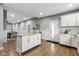 Open kitchen featuring an island with granite counters, white cabinets and open access to the dining area at 953 Harrison St, Indianapolis, IN 46202