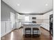 Modern kitchen with white cabinets, stainless appliances, and central island featuring barstool seating at 953 Harrison St, Indianapolis, IN 46202