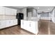 Bright kitchen with white cabinets, a central island, and stainless steel appliances at 953 Harrison St, Indianapolis, IN 46202