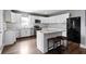 Bright kitchen with white cabinetry, stainless steel appliances, and a center island with seating at 953 Harrison St, Indianapolis, IN 46202