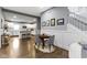 Open living area featuring a round dining table, staircase, and bright, white kitchen at 953 Harrison St, Indianapolis, IN 46202