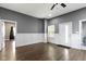 Open-concept living room featuring modern gray walls, wood-look flooring, and white wainscoting at 953 Harrison St, Indianapolis, IN 46202