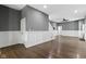 Expansive living room with staircase, stylish wainscoting, and view of connecting rooms at 953 Harrison St, Indianapolis, IN 46202
