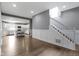 Modern living room featuring stairs and an open floor plan that leads to a bright kitchen at 953 Harrison St, Indianapolis, IN 46202