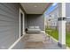 Cozy porch featuring a wicker couch and an end table perfect for relaxing at 953 Harrison St, Indianapolis, IN 46202