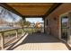 Relax outdoors on this covered, wood-floored back porch, connected to the home via sliding glass door at 1002 Corey Ln, Plainfield, IN 46168