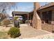 Paver patio features a covered outdoor space attached to a brick home and manicured lawn at 1002 Corey Ln, Plainfield, IN 46168