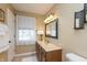 Well-lit bathroom with a decorative mirror, vanity, and an abundance of natural light at 1002 Corey Ln, Plainfield, IN 46168