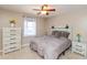 Charming bedroom with natural light, a ceiling fan, dresser, and a comfortable queen size bed at 1002 Corey Ln, Plainfield, IN 46168