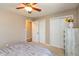 This bedroom offers a comfortable queen bed, ceiling fan, and closet space for easy organization at 1002 Corey Ln, Plainfield, IN 46168