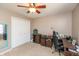 A bright bedroom boasts a ceiling fan, neutral walls, and a mirrored closet, offering ample storage at 1002 Corey Ln, Plainfield, IN 46168